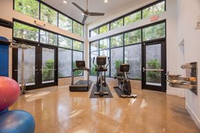 Tigard apartment for rent - A gym with treadmills, exercise balls, and a fan.