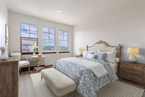 Castle Rock apartment for rent - A bedroom with a large bed and a window overlooking a cityscape.