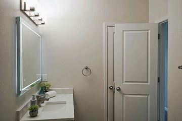 Greenville apartment for rent - A bathroom with a white sink and a mirror above it.