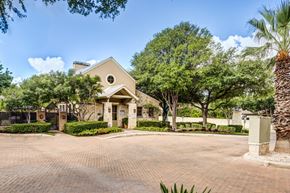 San Antonio townhouse for rent - A house with a driveway and trees in front.