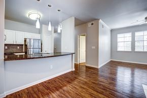 San Antonio townhouse for rent - A kitchen with white cabinets and a wooden floor.