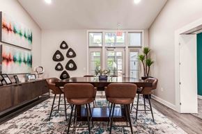 Frederick apartment for rent - leasing center with a table and chairs and a large window