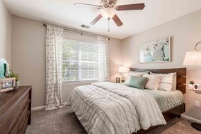 Frederick apartment for rent - a bedroom with a bed and a ceiling fan