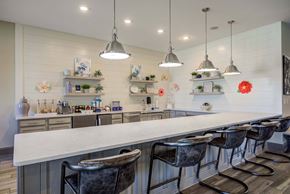 Columbia apartment for rent - a long white bar with chairs in clubhouse kitchen