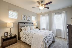 Columbia apartment for rent - a bedroom with a bed and a ceiling fan