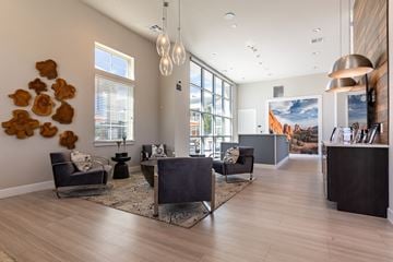 Colorado Springs apartment for rent - a living room with couches and chairs and a reception desk