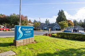 Durham apartment for rent - Tuvalatin View Apartments sign in front of a street with cars and houses.