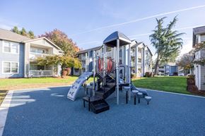 Durham apartment for rent - A playground with a slide and apartments in the background..