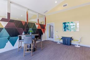 Littleton apartment for rent - a dining room with a table and chairs and a colorful wall