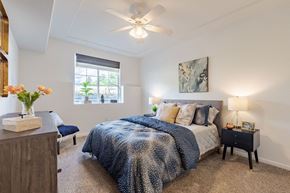 Littleton apartment for rent - a bedroom with a bed and a ceiling fan