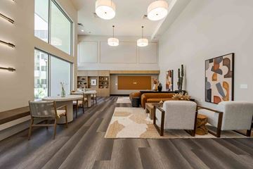 Maricopa apartment for rent - A modern living room with a dining area and a large painting on the wall.