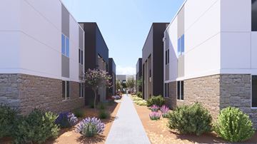 Phoenix apartment for rent - A modern residential area with a pathway and buildings on either side.