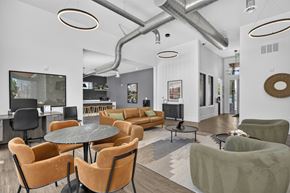 Colorado Springs apartment for rent - A modern living room with a glass wall and a grey sofa.