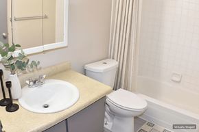 Sparks apartment for rent - A white toilet sits next to a sink in a bathroom.
