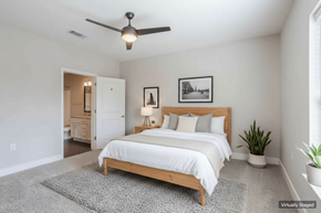 Nashville apartment for rent - A bedroom with a large bed and a ceiling fan.