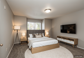 Vancouver apartment for rent - A bedroom with a large bed and a TV on the wall.