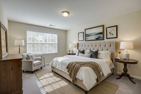 Alexandria apartment for rent - A bedroom with a large bed and a wooden dresser.