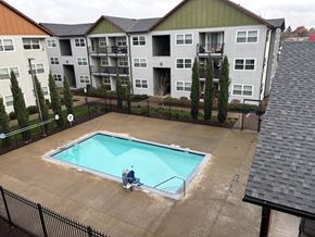 Vancouver apartment for rent - A man is sitting on the edge of a small pool.