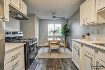 Beaverton apartment for rent - A kitchen with a table and chairs in the middle of it.