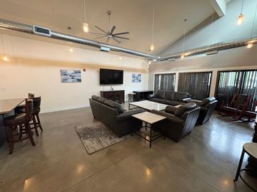 Vancouver apartment for rent - A living room with a grey couch and a television on the wall.