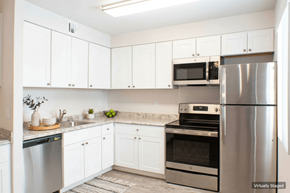 Sparks apartment for rent - A kitchen with white cabinets and stainless steel appliances.