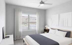 Overland Park apartment for rent - A bedroom with a bed, nightstand, and window with curtains.