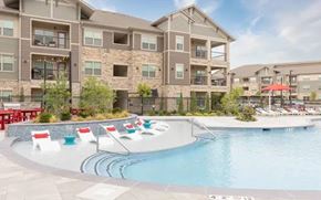 Overland Park apartment for rent - A large swimming pool in front of apartment buildings.