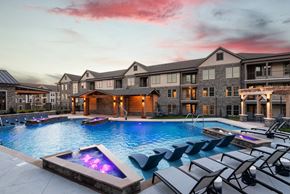 Gallatin apartment for rent - A large house with a pool and lounge chairs.