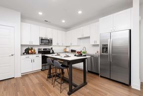 Gallatin apartment for rent - Kitchen with island and barstools, white cabinets, stainless steel appliances and recessed lights