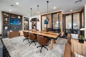 Buford apartment for rent - A modern dining room with a long table and chairs.