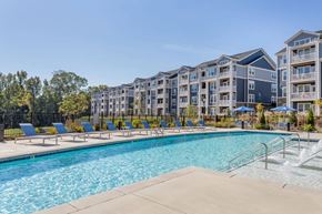 Charlotte apartment for rent - A swimming pool in front of apartment buildings.
