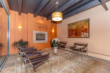 Colorado Springs apartment for rent - A living room with a glass table and chairs.