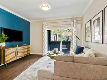 Fort Collins apartment for rent - A living room with a brown couch and a wooden cabinet.
