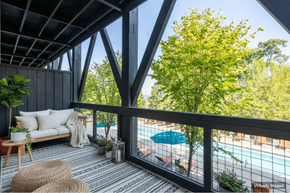 Nashville apartment for rent - A balcony with a couch, plants, and a pool in the background.