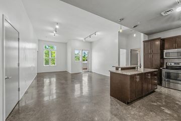 Nashville apartment for rent - A spacious kitchen with brown cabinets and a concrete floor.