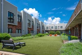 Nashville apartment for rent - A sunny day at a modern residential area with a grassy lawn and benches.