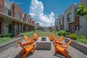 Nashville apartment for rent - A row of orange chairs are arranged in a circle around a fire pit.