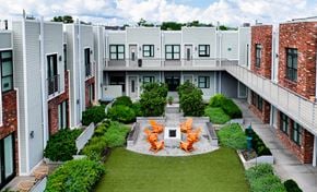 Nashville apartment for rent - A courtyard with a table and chairs in the middle of it.