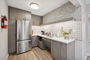Smyrna apartment for rent - A modern kitchen with a stainless steel refrigerator and a white countertop.