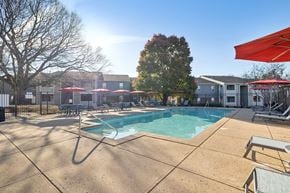 Smyrna apartment for rent - A pool area with sun loungers and umbrellas.