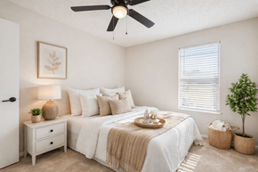 Smyrna apartment for rent - A bedroom with a bed, nightstand, and a ceiling fan.