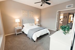 Pearl apartment for rent - a bedroom with a bed and a ceiling fan