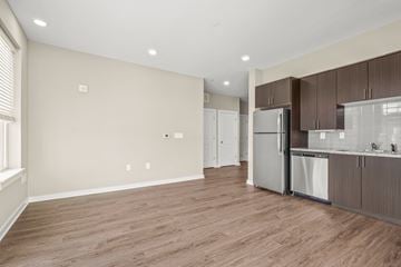 Nashville apartment for rent - a kitchen and living room with wood flooring and a stainless steel refrigerator