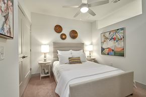 Hunstville apartment for rent - A bedroom with a large bed and a ceiling fan.