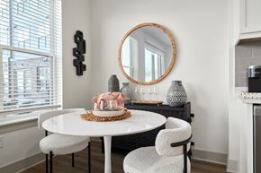 Hunstville apartment for rent - A white dining table with a pink cake and two chairs.