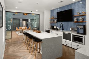 Franklin apartment for rent - A modern kitchen with a bar area and a television mounted on the wall.
