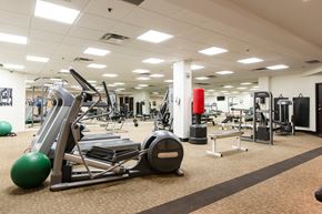 Toronto apartment for rent - A gym with a variety of equipment including a leg press machine.