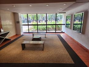 Toronto apartment for rent - A room with a bench and a table in front of a window.