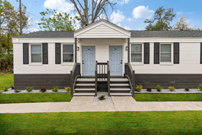 North Charleston apartment for rent - the front of a white house with blue doors and a porch