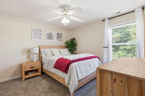 Fayetteville apartment for rent - A bedroom with a bed, nightstand, and window.
